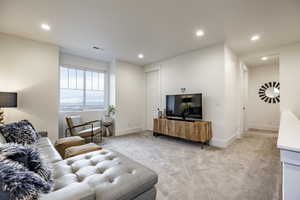 Living room featuring light colored carpet