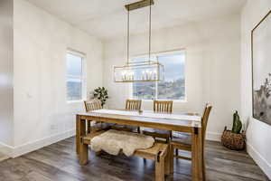 Dining room featuring a chandelier and dark wood-type flooring