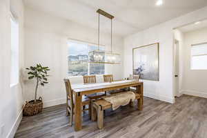 Dining room featuring a chandelier and wood-type flooring