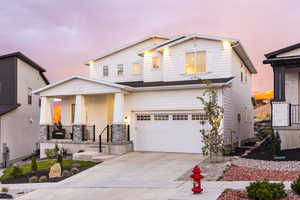 View of front of home featuring covered porch and a garage