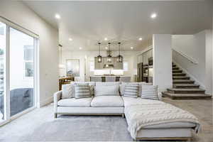 Living room featuring sink and light colored carpet