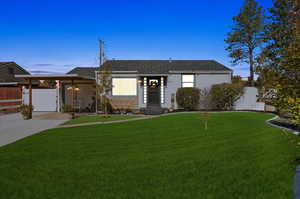 View of front of house featuring a yard and a carport