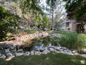 View of yard with a balcony