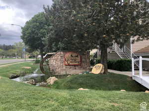 Community / neighborhood sign with a lawn