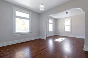 Unfurnished room featuring dark hardwood / wood-style floors