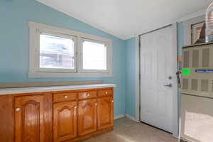 Bathroom featuring tile patterned flooring and lofted ceiling