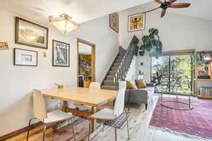 Dining space featuring light hardwood / wood-style floors, lofted ceiling, and ceiling fan