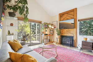 Living room featuring high vaulted ceiling and light wood-type flooring