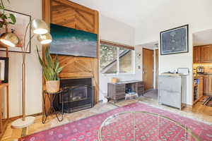 Living room with light wood-type flooring and vaulted ceiling