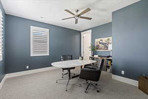 Office area with carpet flooring, a textured ceiling, ceiling fan, and plenty of natural light