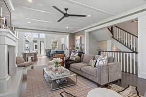 Living room with ceiling fan and wood-type flooring