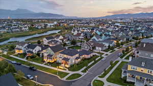 Aerial view at dusk featuring a water and mountain view