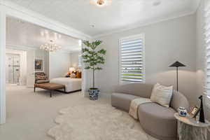 Bedroom with wooden ceiling, a notable chandelier, light carpet, and ornamental molding