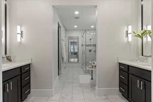 Bathroom featuring walk in shower and vanity