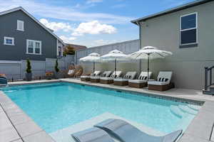 View of swimming pool with pool water feature and a patio area