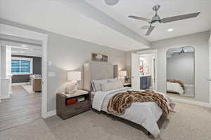 Bedroom featuring wood-type flooring, ceiling fan, and ensuite bathroom