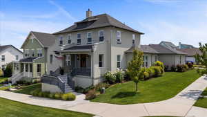 View of front of property featuring a front yard and covered porch