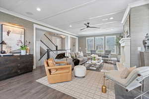 Living room featuring dark hardwood / wood-style flooring and ceiling fan