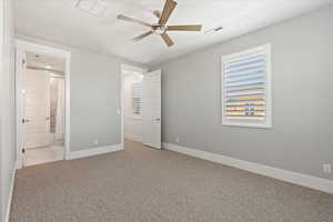 Unfurnished bedroom with light colored carpet, ceiling fan, and connected bathroom