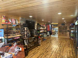 Interior space with wooden walls, wood-type flooring, and wood ceiling