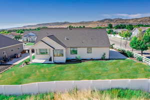 Rear view of property featuring a fenced backyard and a mountain view