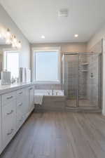 Full bath featuring visible vents, a healthy amount of sunlight, vanity, and a stall shower