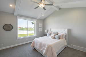 Bedroom with baseboards, visible vents, carpet flooring, and lofted ceiling with beams