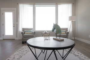 Living area with baseboards and light wood-style floors