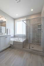 Bathroom featuring visible vents, a bath, and a shower stall