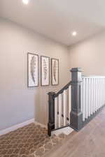 Staircase featuring baseboards and recessed lighting