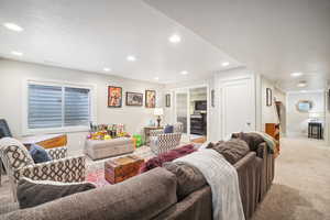 Living room featuring a textured ceiling and light carpet