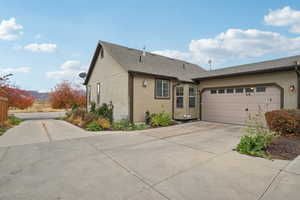 View of front of house with a garage and a mountain view