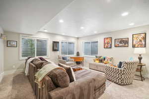 Living room with light colored carpet and a textured ceiling