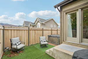 View of yard with a hot tub and a mountain view