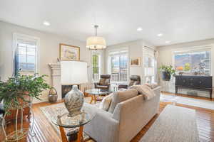 Living room with a textured ceiling and hardwood / wood-style flooring