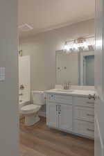 Full bathroom featuring vanity, wood-type flooring, bathtub / shower combination, and toilet