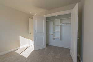 Unfurnished bedroom featuring carpet floors and a closet