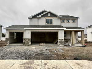 View of front of home featuring a porch and a garage