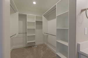 Spacious closet with light colored carpet