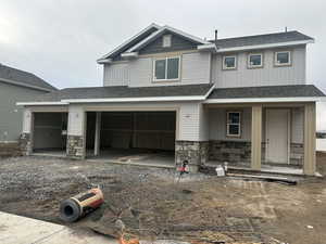 Craftsman house featuring a garage