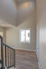 Interior space featuring wood-type flooring and a high ceiling