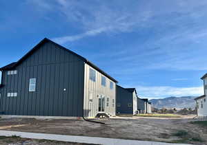 View of side of home with a mountain view