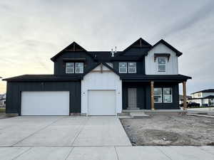 View of front facade with a porch and a garage