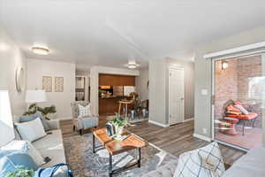 Living room featuring washer and clothes dryer and dark hardwood / wood-style flooring