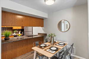 Dining room featuring dark wood-type flooring