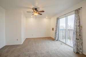 Carpeted empty room with ceiling fan