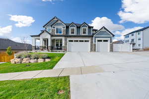 Craftsman-style house with a front lawn, a garage, and covered porch