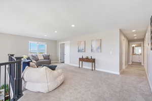 Carpeted living room featuring a textured ceiling