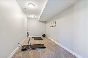 Workout room with carpet and a textured ceiling