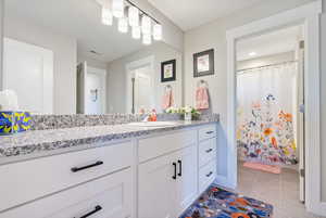 Bathroom featuring tile patterned flooring and vanity